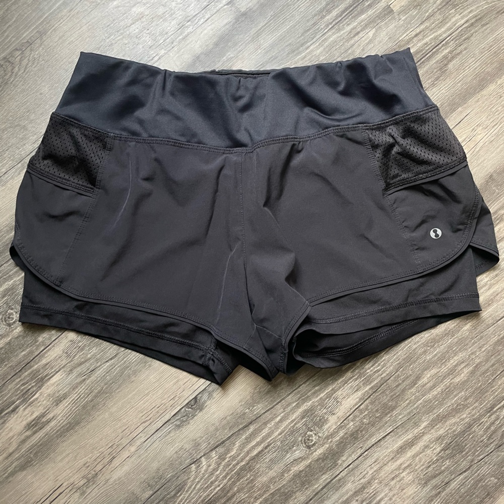 Black athletic shorts, size medium.